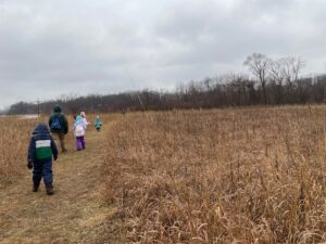 Winter hikers in restored prairie