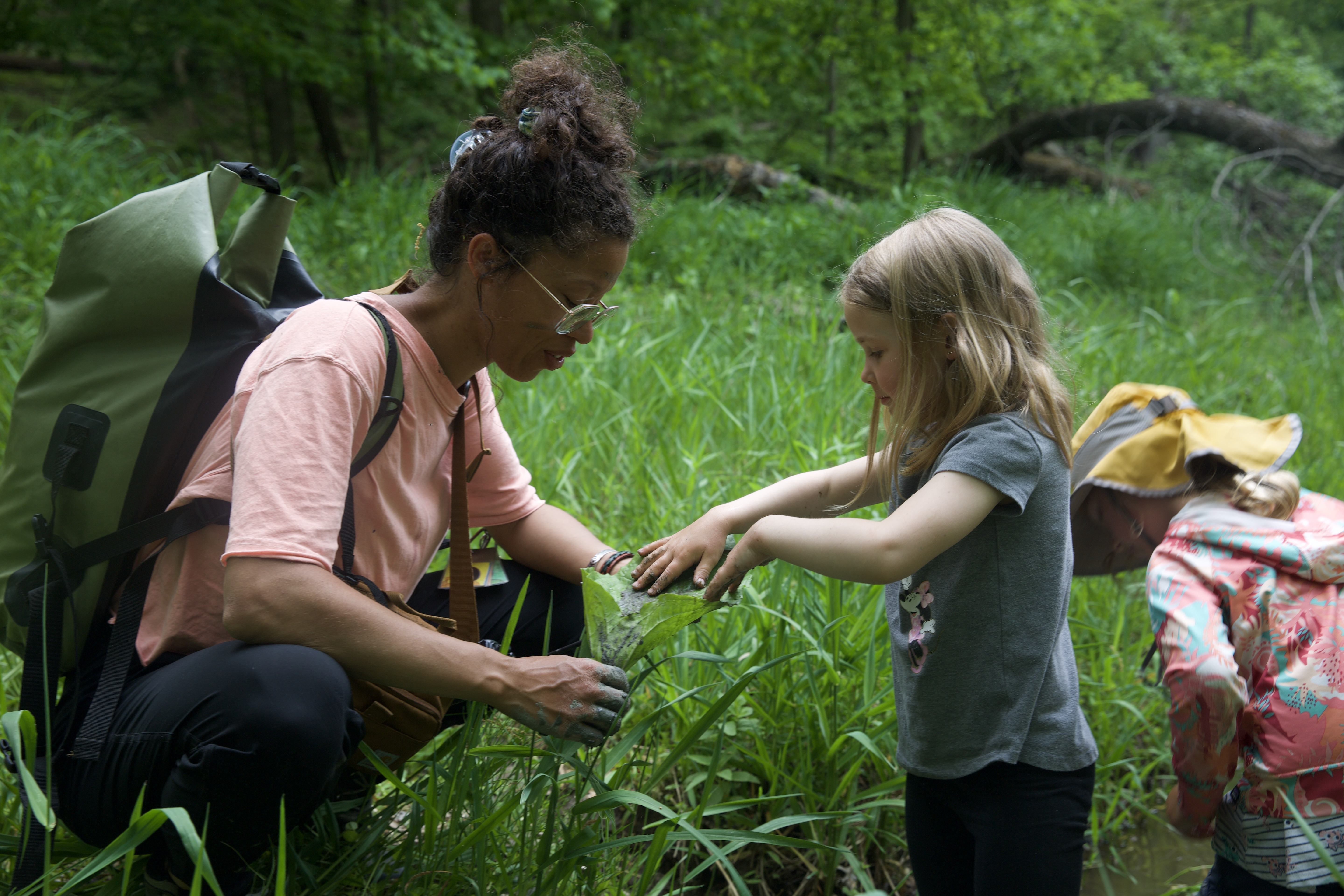 CFS student and teacher playing in creek
