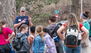 Volunteer leading a maple syruping program